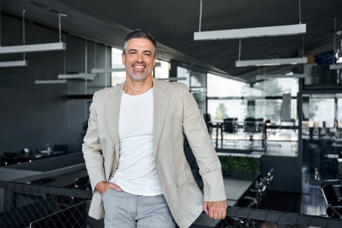 corporate business man leaning on boardroom desk
